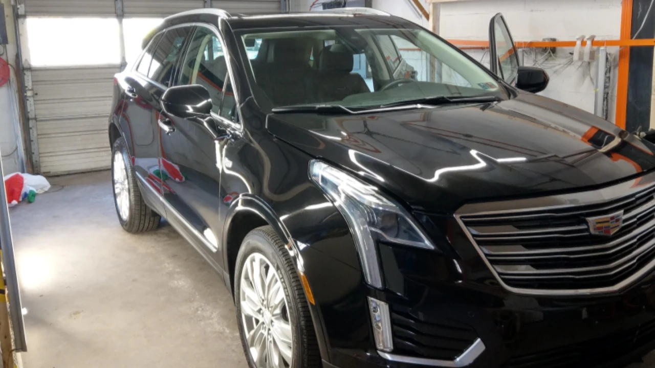 Machine polishing a Cadillac during paint correction and swirl removal